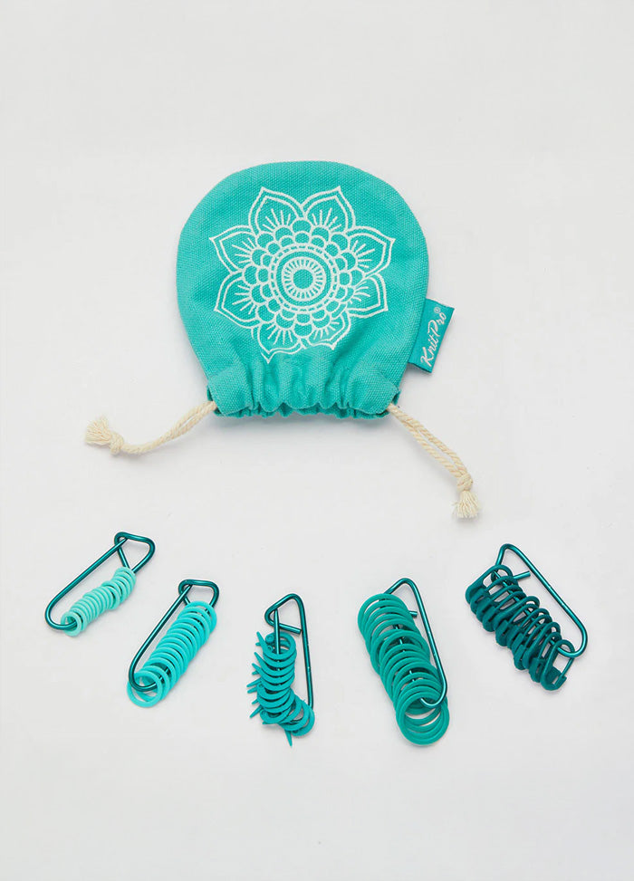 A green bag with green markers inside, representing a neat and attractive assortment of knitting tools.