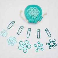 A teal cloth bag filled with 100 color-coded stitch markers and a separate bag of paper clips for easy organization.