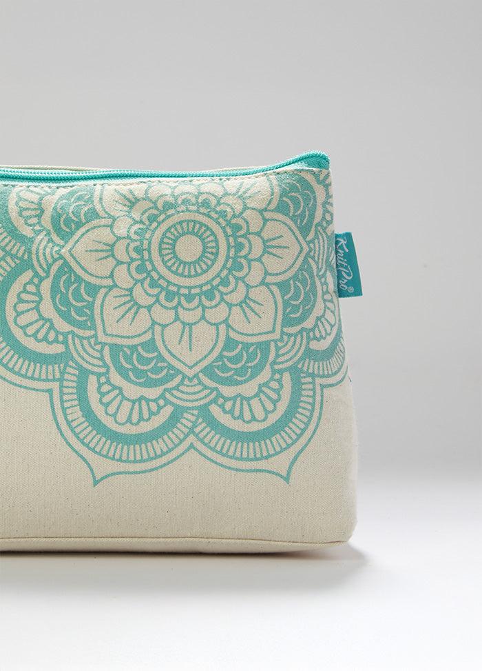 Floral-patterned white and turquoise cosmetic bag, ideal for knitting supplies, with a mandala charm and inner pocket.