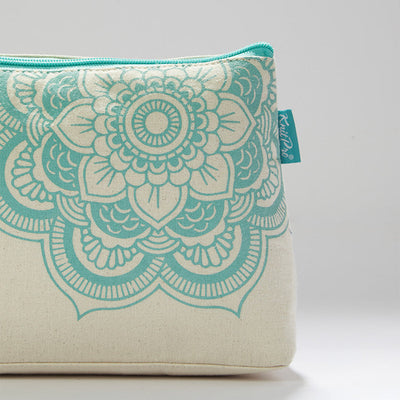 Floral-patterned white and turquoise cosmetic bag, ideal for knitting supplies, with a mandala charm and inner pocket.