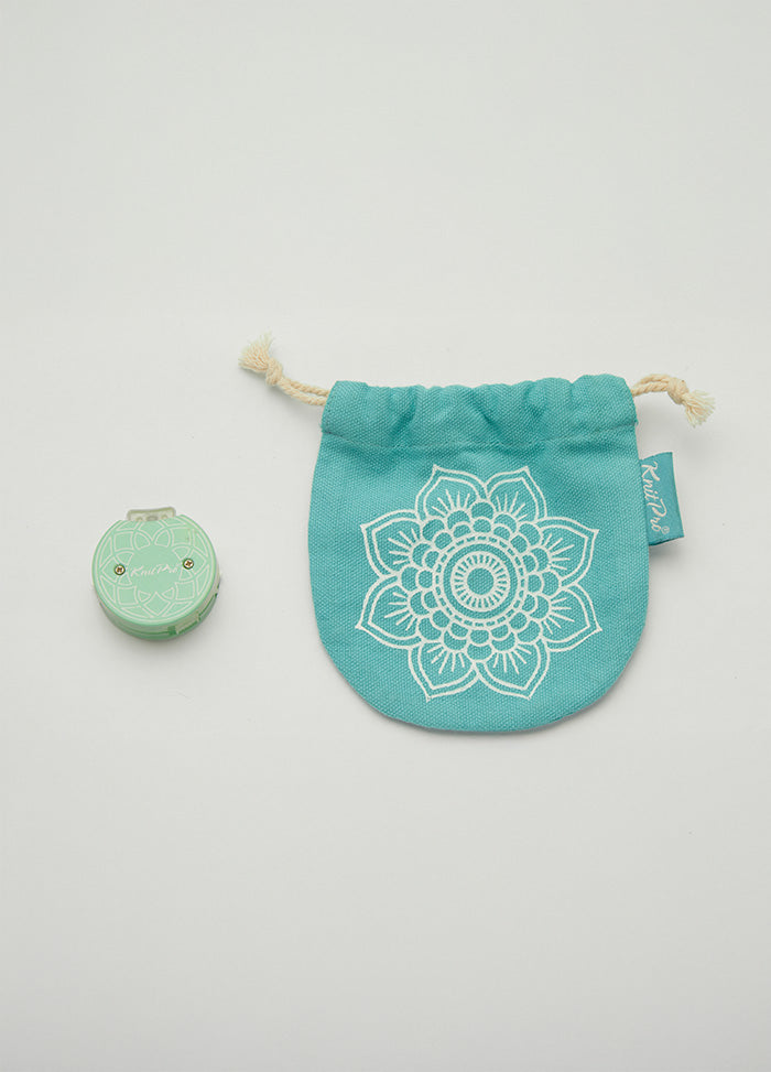 Small teal bag with a mandala design and turquoise flower, designed to hold a knitting tool for tracking rows.