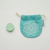 Small teal bag with a mandala design and turquoise flower, designed to hold a knitting tool for tracking rows.