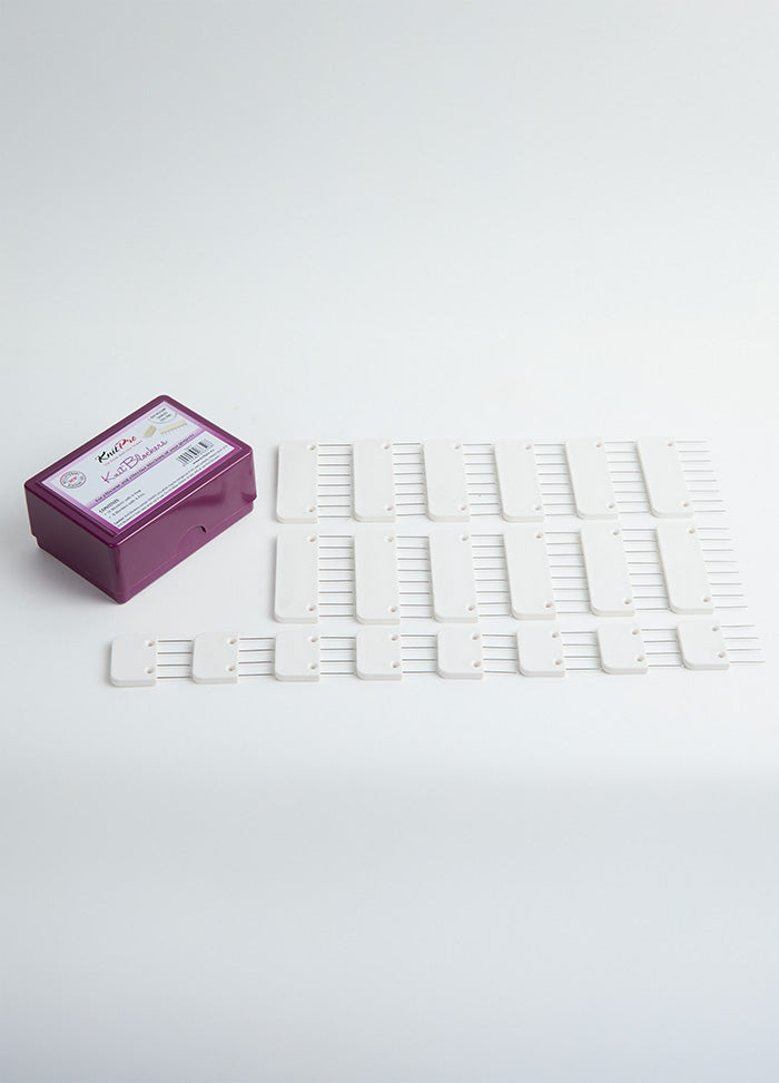 A white plastic tray containing 20 knit blockers with durable pins, designed for securing and maintaining tension in knit projects.