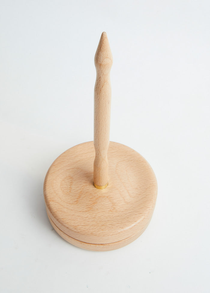 Wooden toothpick holder featuring a handle for convenient use and storage of toothpicks.