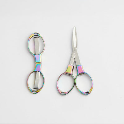 Colourful scissors with a rainbow handle and shiny metal blades, designed to fold for protection from sharp points.