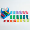 A box containing colorful plastic blocking blocks, designed with stainless steel pins for securing knit and crochet pieces.
