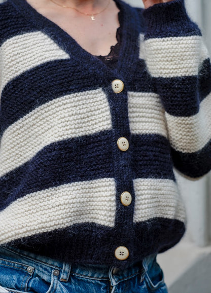 Daily Stripes Cardigan: Navy and white striped knit with beige buttons, layered over a black lace top.