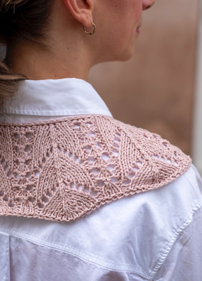 Yours Truly Collar: Pink lace-knit accessory with leaf motifs, styled over a white shirt from the back view.