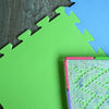 Colorful puzzle mat featuring green and blue pieces, designed for easy assembly and versatile project sizes.