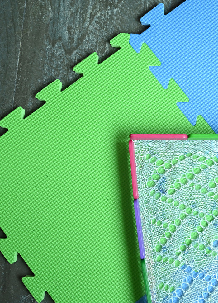 Colorful puzzle mat featuring green and blue pieces, designed for easy assembly and versatile project sizes.