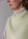 Fonkel Collar: high knitted collar with alternating rows of white and light yellow-green in a textured pattern.
