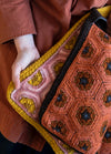 Papaver Bag: multicolored crocheted bag with hexagonal motifs in orange, brown, pink, yellow, and black.