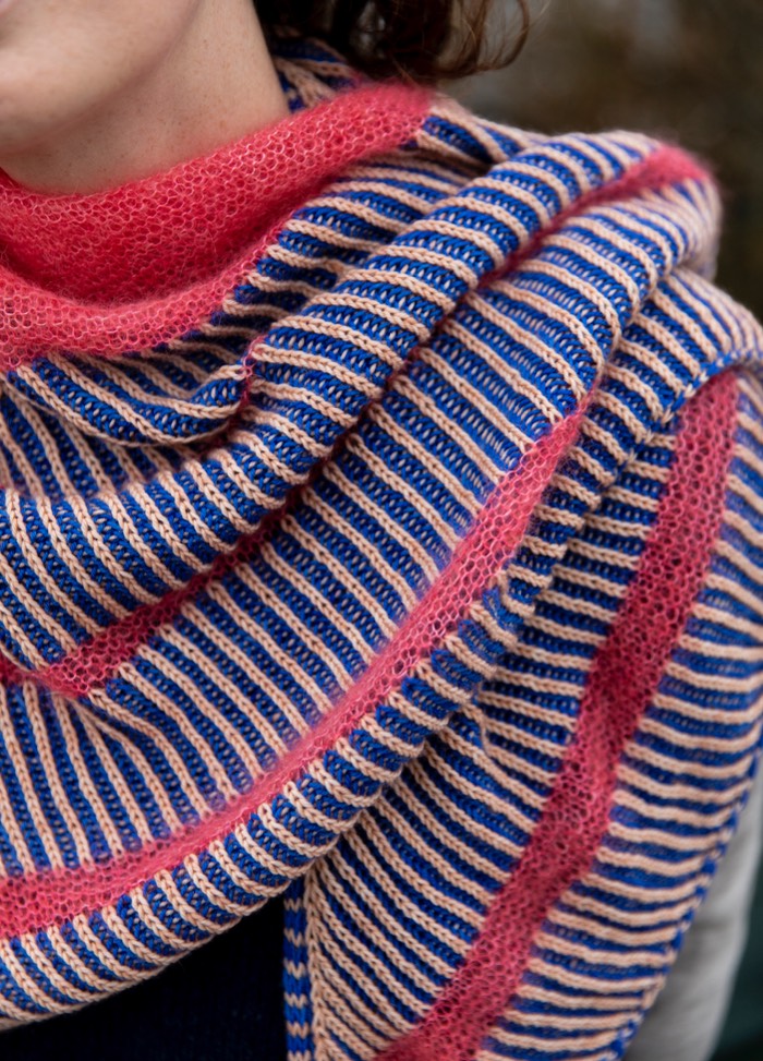 Bubblegum Shawl: knitted shawl with alternating blue and beige stripes, bordered by pink sections.
