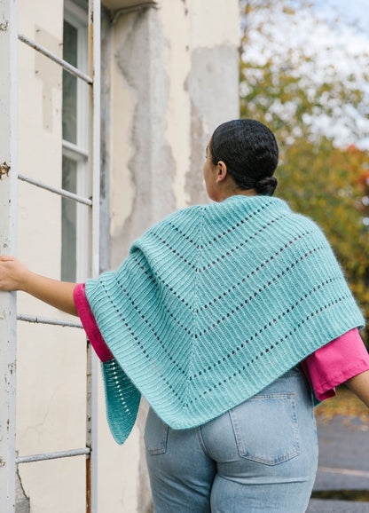Poseidon Ridge Shawl: light blue textured shawl with horizontal lines, draped over shoulders and back