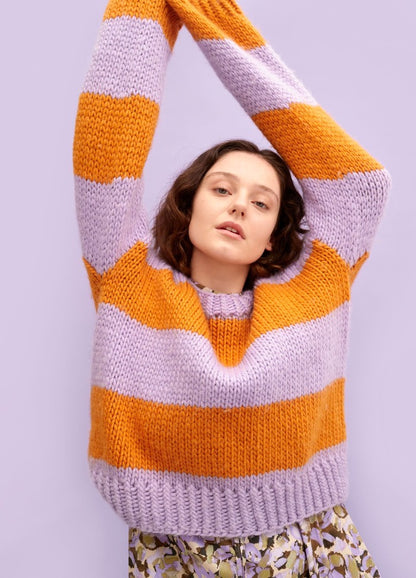 Tivoli Sweater: striped orange and light purple knit with raised arms against a light purple background