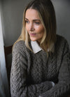Lempi Sweater: grey cable-knit worn over white collared shirt, featuring intricate wool texture.