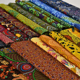 Collection of colorful fabric rolls with various patterns