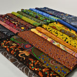 Collection of colorful fabrics with intricate patterns on a white background