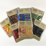 Packets of Warrina Designs fabric packs with various patterns on a white background