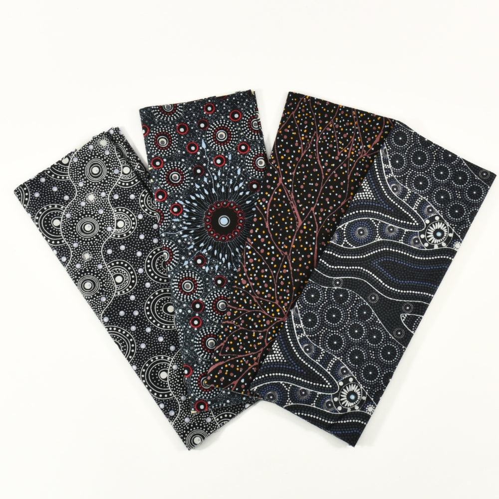 Four fabric swatches with Aboriginal dot pattern on a white background