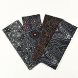 Four fabric swatches with Aboriginal dot pattern on a white background