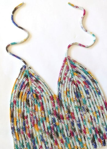 Crochet multicoloured top with a ribbed pattern, featuring vibrant hues of blue, yellow, and red. The ties are loosely coiled above.