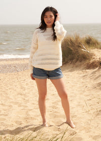 Oat knitting pattern, a neutral-toned sleeveless top with subtle ribbing and a relaxed fit, ideal for layering in warm weather.
