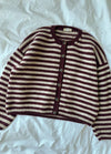 Olga Jacket in maroon and white horizontal stripes with button-up front, laid out on a white sheet.