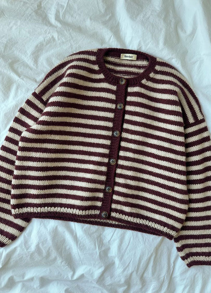 Olga Jacket in maroon and white horizontal stripes with button-up front, laid out on a white sheet.
