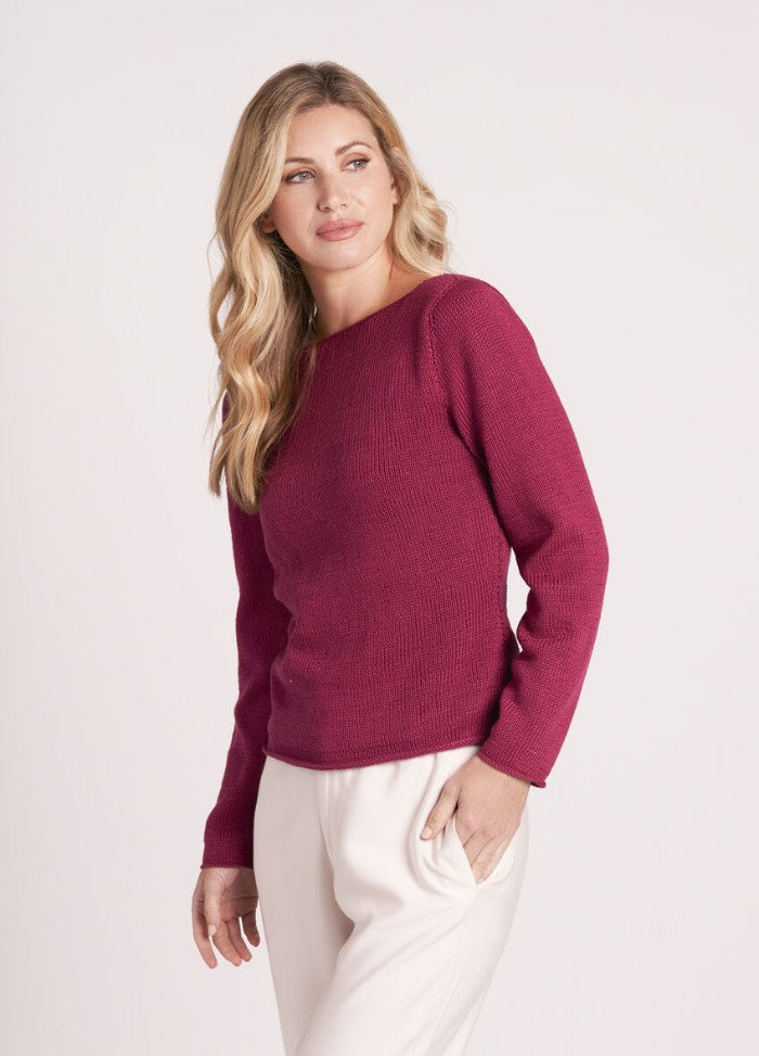 Model wearing a sleeveless lace-knit top in pale cotton yarn, styled for summer layering.