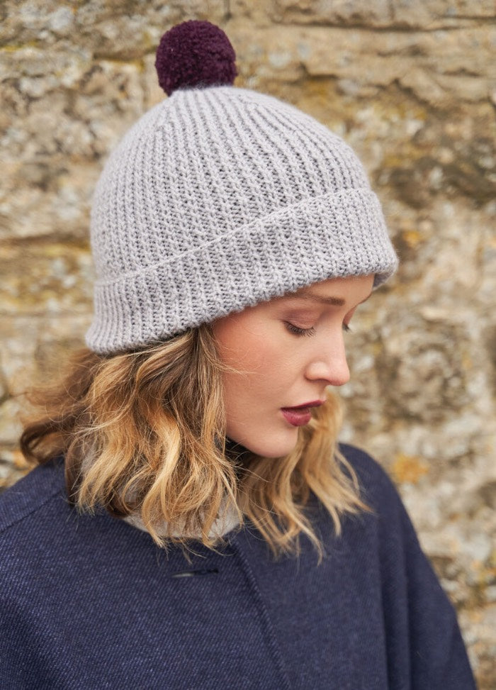 Classic beanie in all-over twisted rib with a folded brim, optionally topped with a pom-pom; knit in round-friendly Alpaca Soft DK.