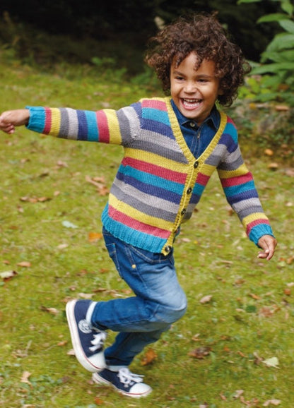 Child in striped Outlaw Cardigan in blue, yellow, red, and gray, with jeans and sneakers.