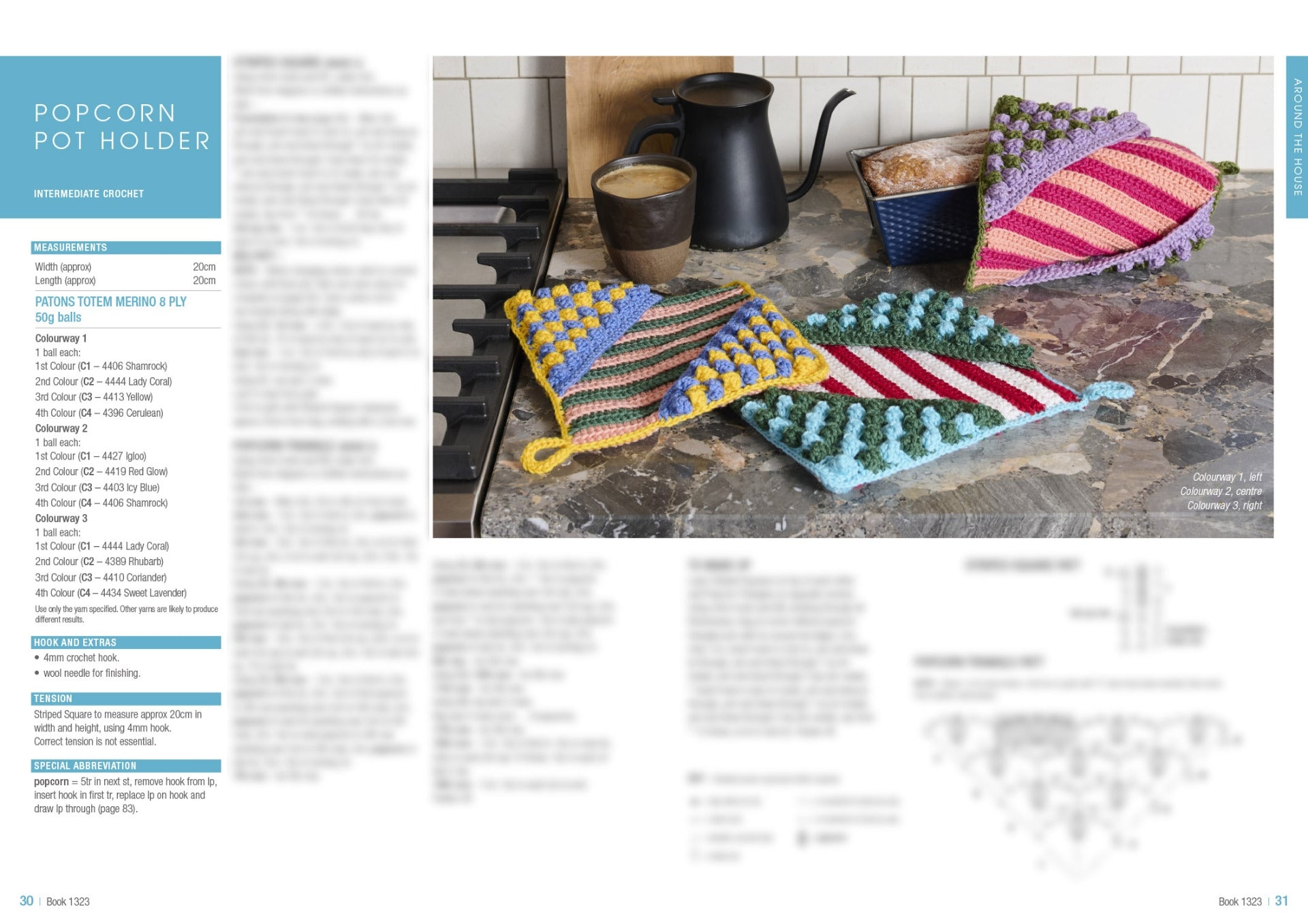 Colorful crocheted pot holders with popcorn stitches sit on a kitchen counter next to a mug and kettle. Cozy and handmade vibe.