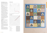Crocheted blanket with multicolored squares, some featuring rainbow designs, bordered in blue. Blurred text and crochet diagrams on the left.