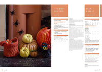 Festive Halloween scene with knitted pumpkins and treat baskets on a fireplace. Plastic spiders adorn the wall, and a paper pumpkin adds charm.