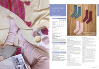 A cozy scene with a person lounging on a beige couch, wearing pink knit socks, holding a magazine. A tray with tea, and knitted items is nearby. Emphasizes comfort.