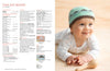A baby in a polka dot onesie smiles while wearing a knitted teal and brown Fair Isle beanie. A wooden rattle lies near the baby. Pattern instructions are displayed to the left.