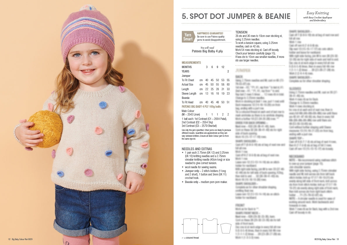 Young child smiling, wearing a colorful polka dot sweater and beanie, holds a yellow ball. Pattern instructions are visible beside her on a white panel.