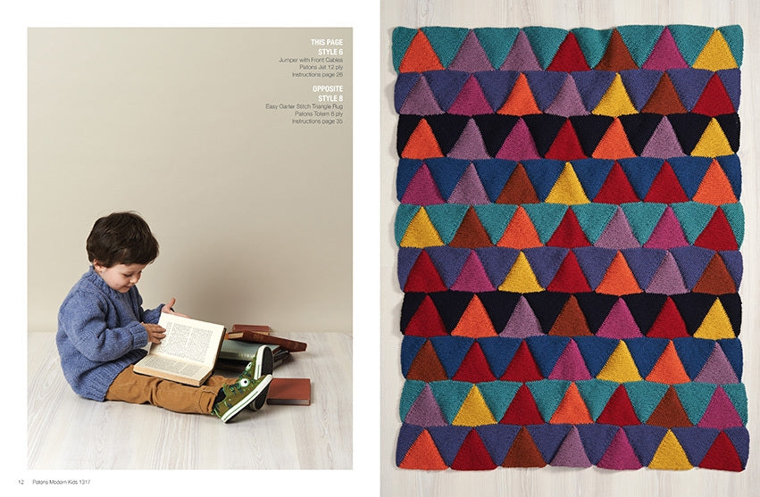 A young child in a blue sweater reads a book on a wooden floor, surrounded by stacked books. Adjacent is a colorful knitted pattern of overlapping triangles.