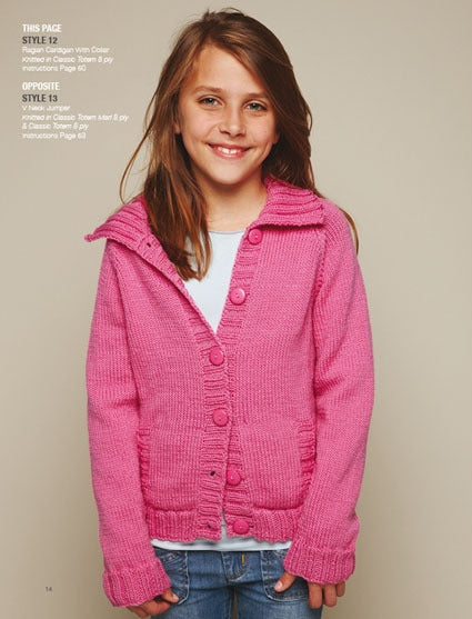 Girl smiling in a bright pink knitted cardigan with large buttons, over a white shirt and blue jeans. The background is neutral, conveying a cheerful tone.