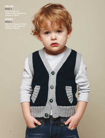 Toddler with curly hair wearing a gray and navy buttoned vest over a light gray shirt and jeans. The neutral background highlights a thoughtful expression.