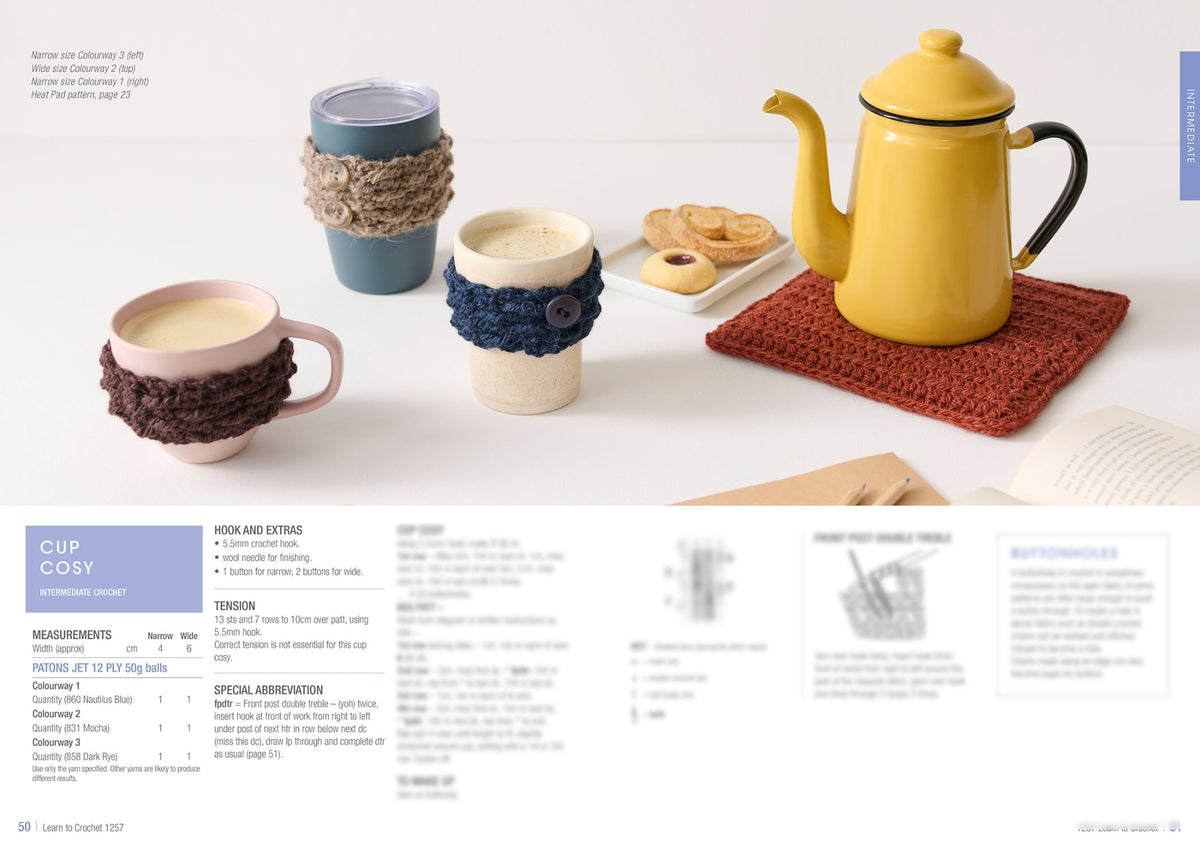 Cozy scene with a yellow teapot on a crocheted mat, three cups with knitted cozies, and a plate of cookies. Craft instructions are partially visible. Warm, inviting tone.