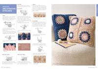 Crochet instructions page showcases decorative stitches, alongside two colourful cushion covers with floral patterns on a soft armchair.