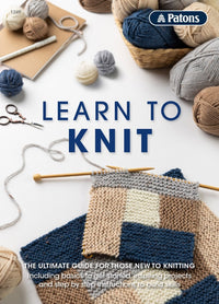 Knitting supplies with blue and beige yarn balls, needles, and a knitted patchwork swatch. Text reads "Learn to Knit" with a cozy, inviting feel.