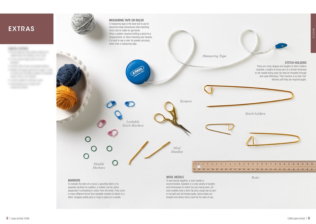 A crafting essentials layout showing yarn balls, measuring tape, scissors, stitch holders, markers, needles, and a ruler on a light background.