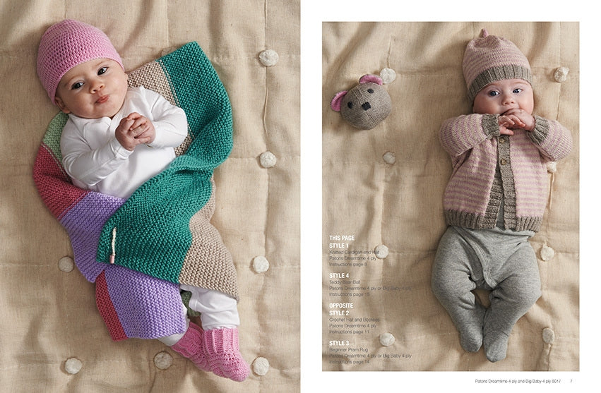 Two babies lying on a quilted surface. Left baby is in a pink hat and multicolored knit blanket, right baby wears a pink knit outfit with a mouse toy. Cozy and playful.