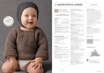 A smiling baby wearing a knitted, brown sweater with buttons and a matching gray beanie sits on a gray surface. Text on the right describes "Garter Stitch Jumper" knitting instructions and materials. The tone is warm and cozy.