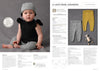 A baby in a knitted outfit with a black top, grey pants, and matching hat sits on the left. On the right, there are grey and yellow leggings, a small toy, and knitting instructions. The mood is cozy and cute.