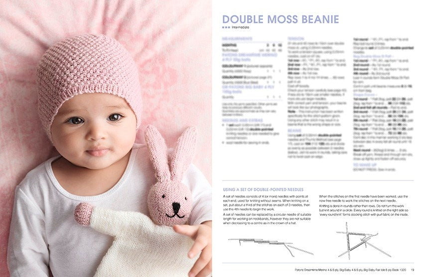 A baby wearing a pink knitted beanie lies on a soft pink blanket, cuddling a white and pink stuffed bunny. The mood is serene and cozy. Adjacent is a knitting pattern titled "Double Moss Beanie."