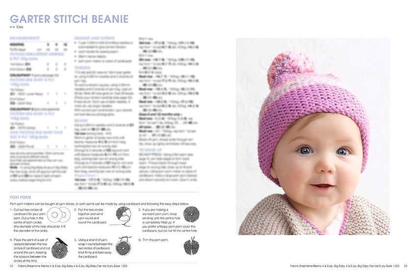 A baby in a pink knitted beanie with a pom-pom, smiling warmly. The left page contains knitting instructions for a garter stitch beanie.